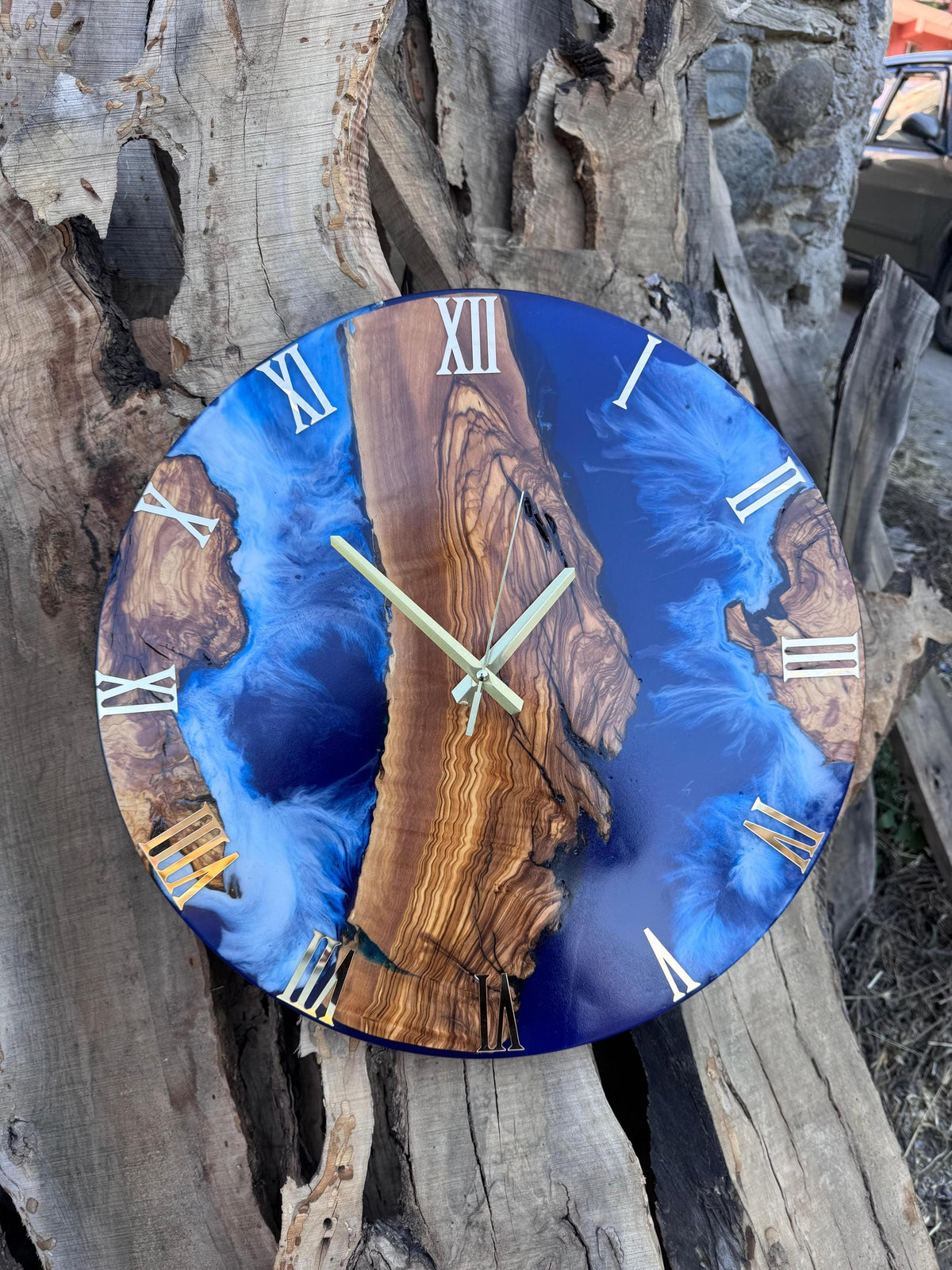 Overhead flat lay of the live edge olive wood coastal clock highlighting wood grain and blue resin