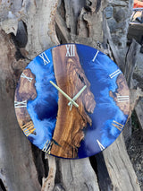 Overhead flat lay of the live edge olive wood coastal clock highlighting wood grain and blue resin