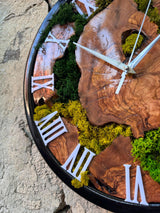 Preserved moss wall clock above a couch in a cosy biophilic bedroom
