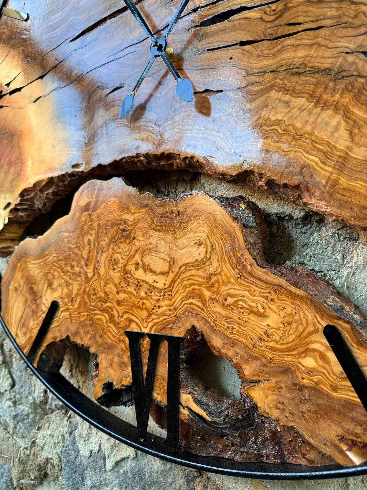 Olive wood wall clock hung in a farmhouse kitchen