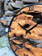 Size scale reference for the oversized olive wood wall clock beside common household objects