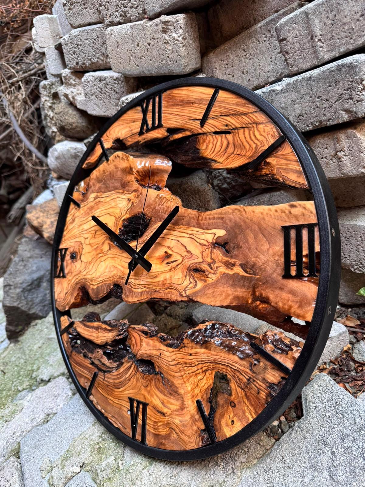 Back of the oversized olive wood wall clock showing mounting hardware and clock mechanism