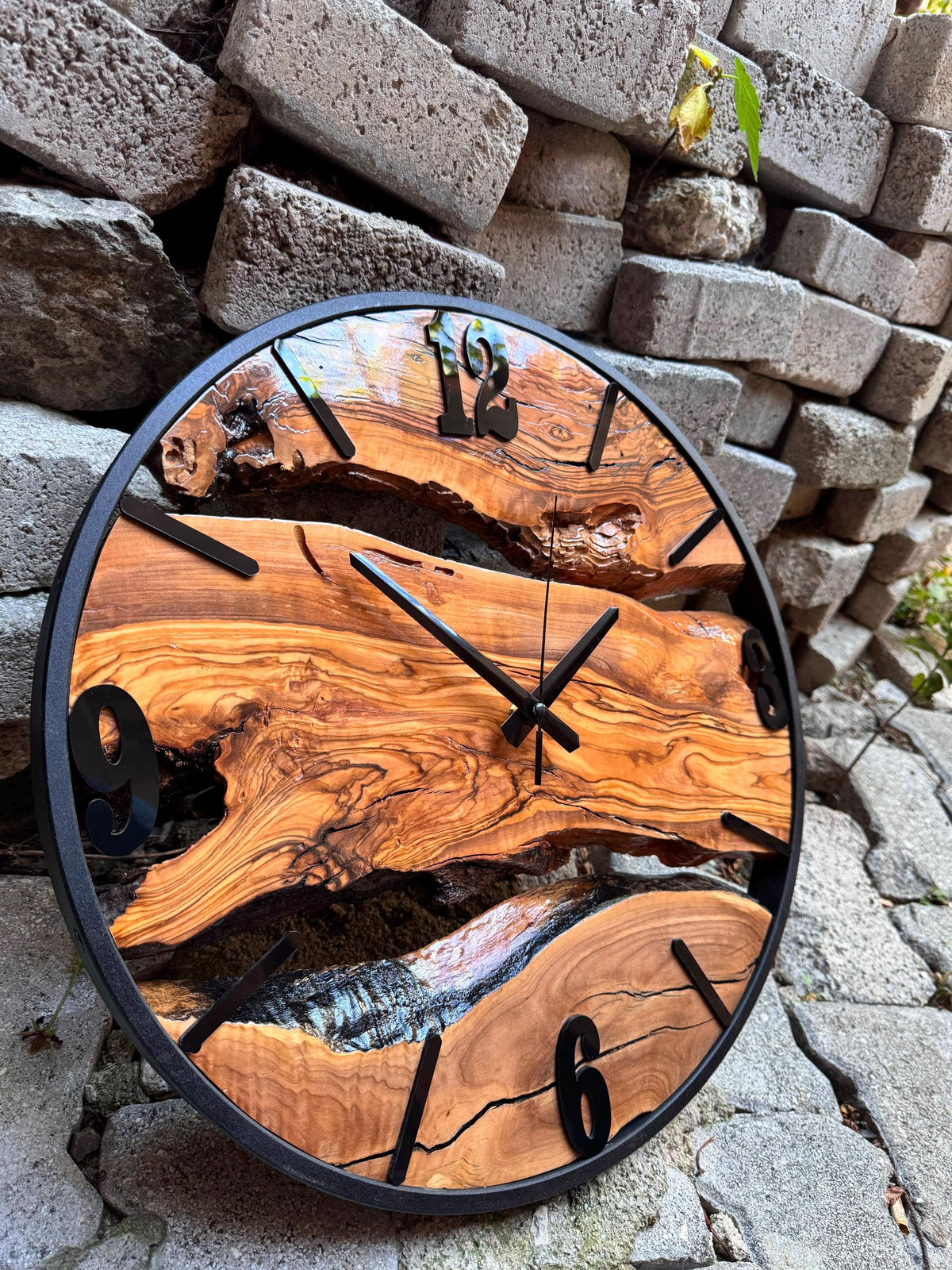 Close-up texture of the handmade wood clock revealing rich olive wood grain and organic live edge detail