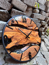 Close-up texture of the handmade wood clock revealing rich olive wood grain and organic live edge detail