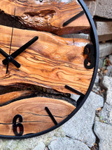 Natural wood clock in a modern living room as a statement wall clock above a neutral sofa