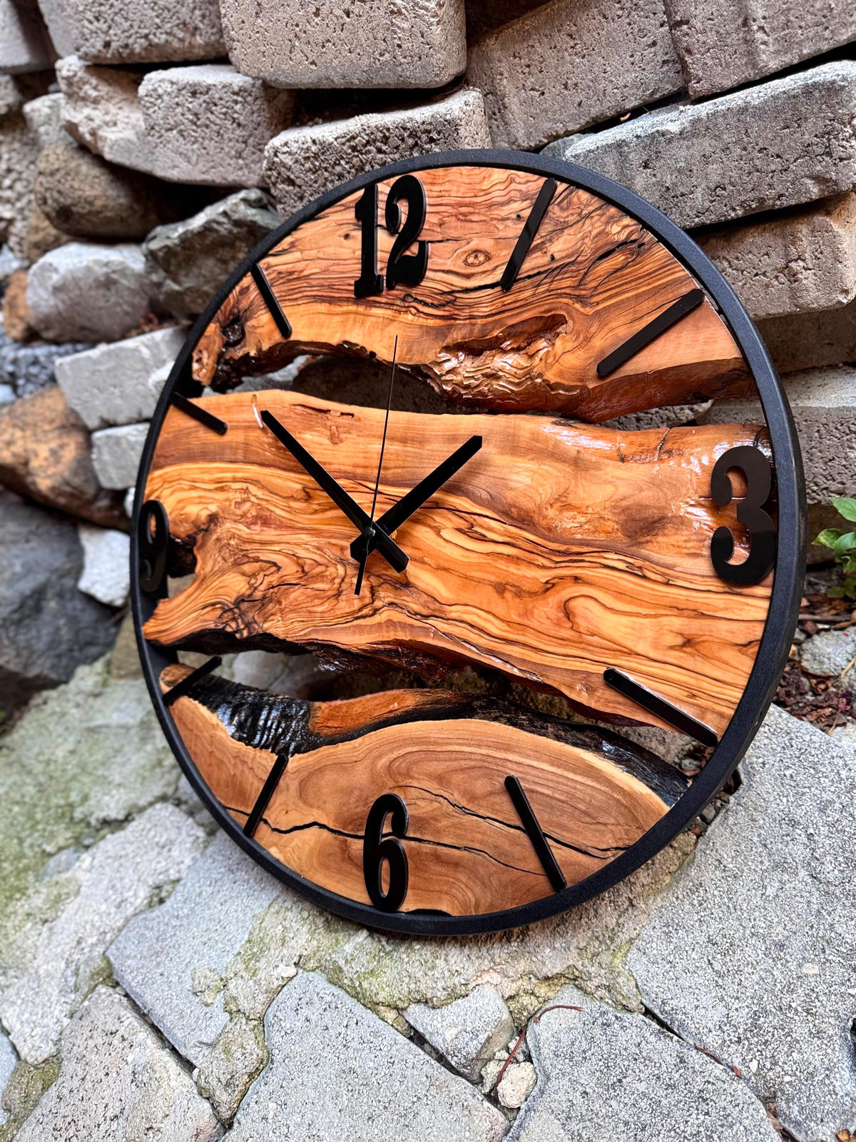 Size scale comparison showing the oversized natural wood timepiece next to common objects
