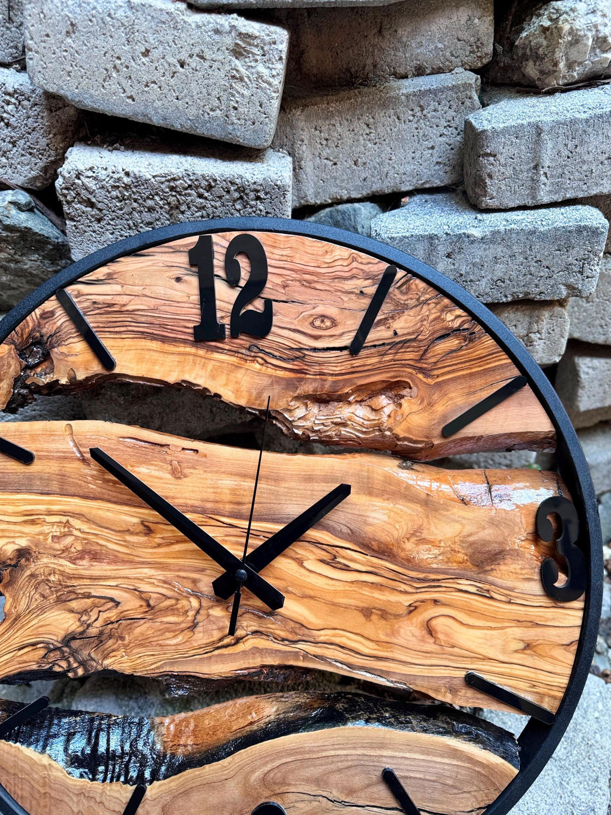 Large rustic clock mounted on a white wall as live edge wall art in minimalist decor