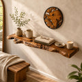 Reclaimed olive wood floating shelf with live edge, mounted on a wall