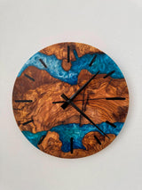 Live edge olive wood resin wall clock with deep blue ocean resin and natural grain detail