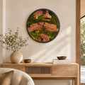 Large live-edge olive wood wall clock with preserved green moss, natural grain and black clock hands