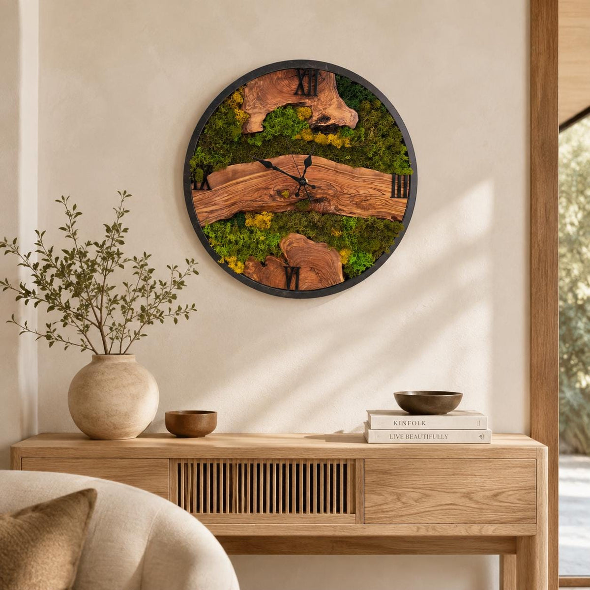 Large live-edge olive wood wall clock with preserved green moss, natural grain and black clock hands