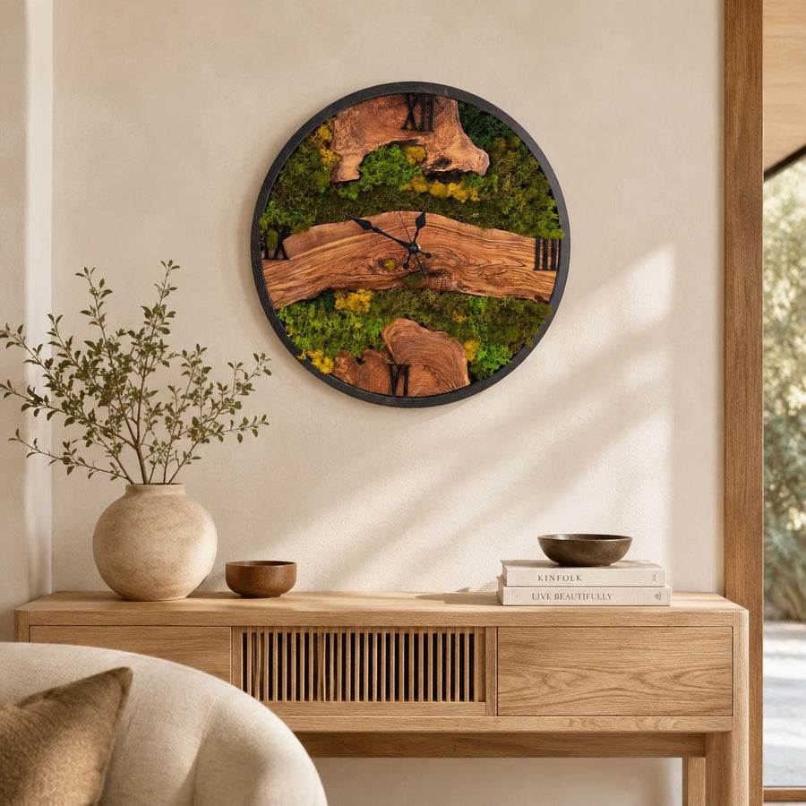 Large live-edge olive wood wall clock with preserved green moss, natural grain and black clock hands