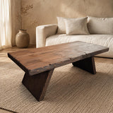 Handmade solid cedar live edge coffee table in a warm Japandi living room, showing the thick top and angled slab legs