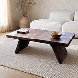 Front angled view of the dark brown solid cedar coffee table with a live edge top