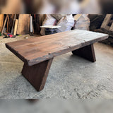Workshop photo of the handmade cedar coffee table showing its live edge, thick top and solid slab legs