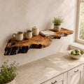 Natural olive wood floating shelf with live edge, mounted on a wall