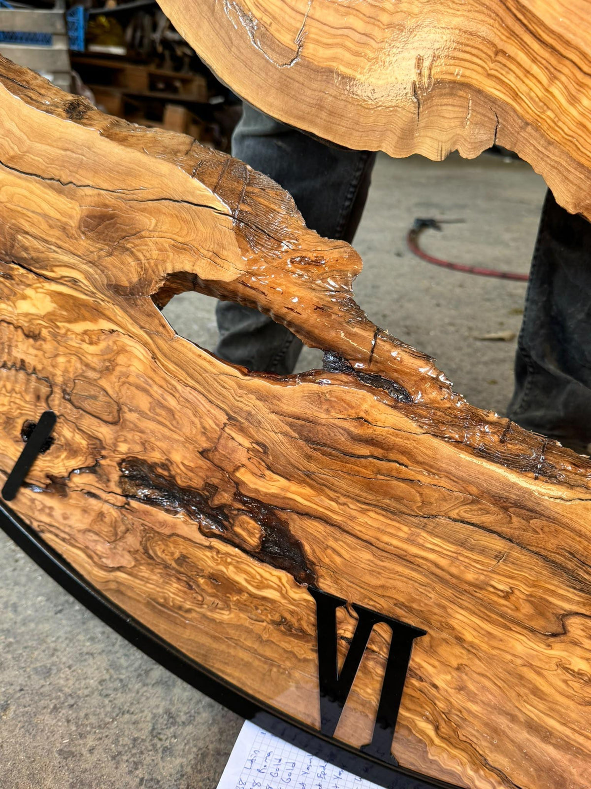 Close-up of grain and live edge detail near the Roman numeral IX