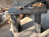 Rustic solid wood entryway table at an angle, showing top depth and leg proportions