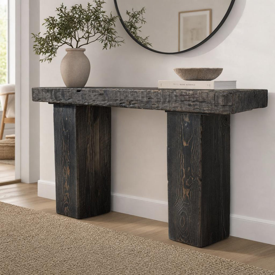 Reclaimed wood console table in a bright modern entryway with natural light and minimal decor