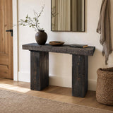 Narrow solid wood console table in a Scandinavian hallway showing its space-saving design