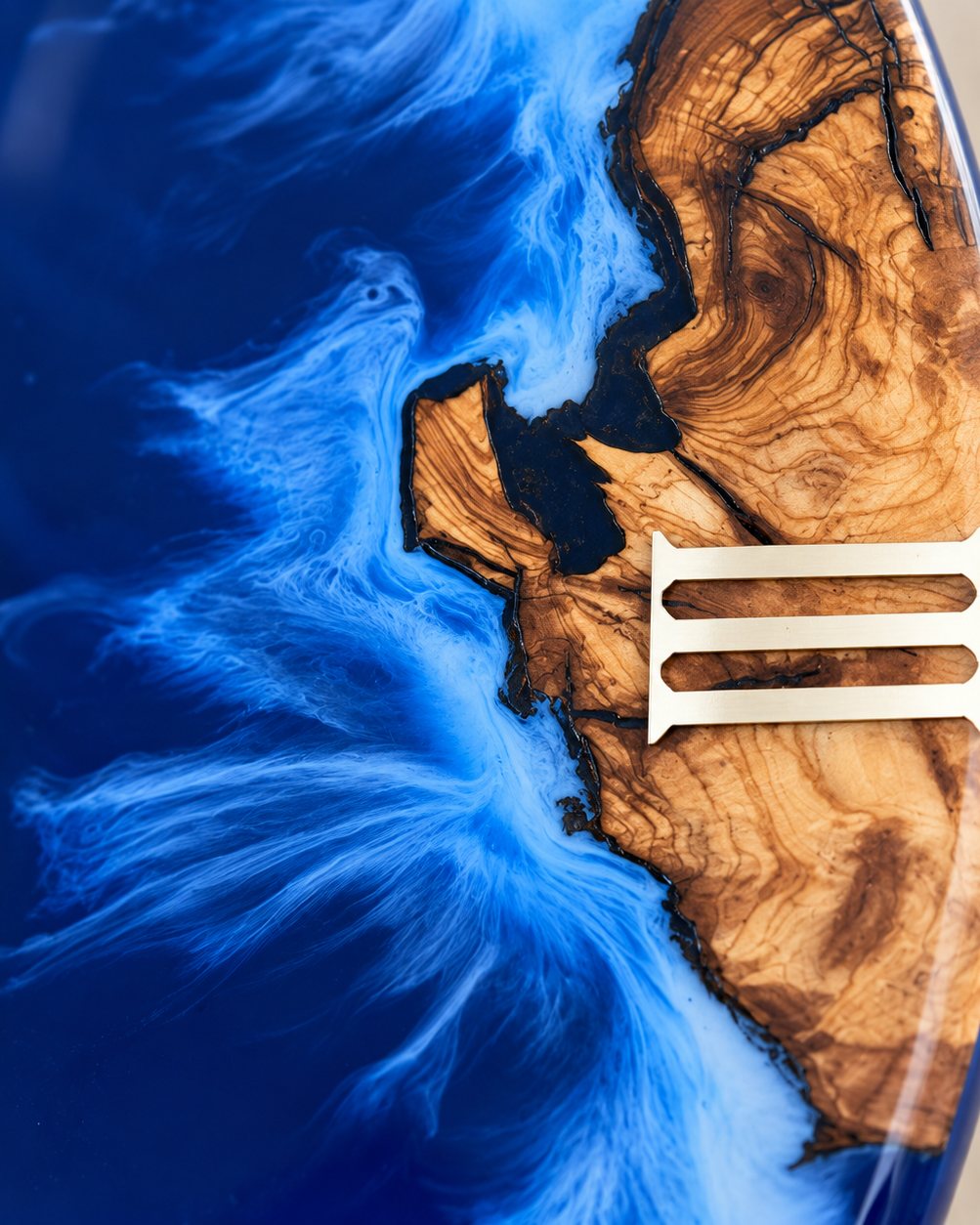 Close view of olive grain meeting cobalt Ocean epoxy on a clock face